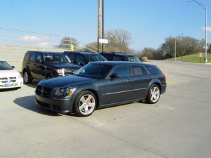 Blue Dodge Magnum SRT8 parked among other cars in the dealer lot